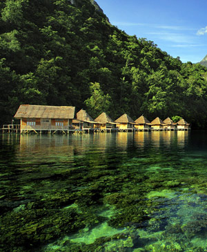 Huts standing in crystal clear water