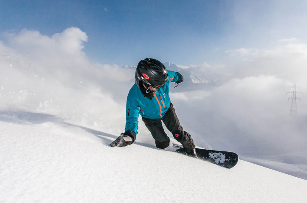 Man snowboarding down mountain in Verbier Switzerland