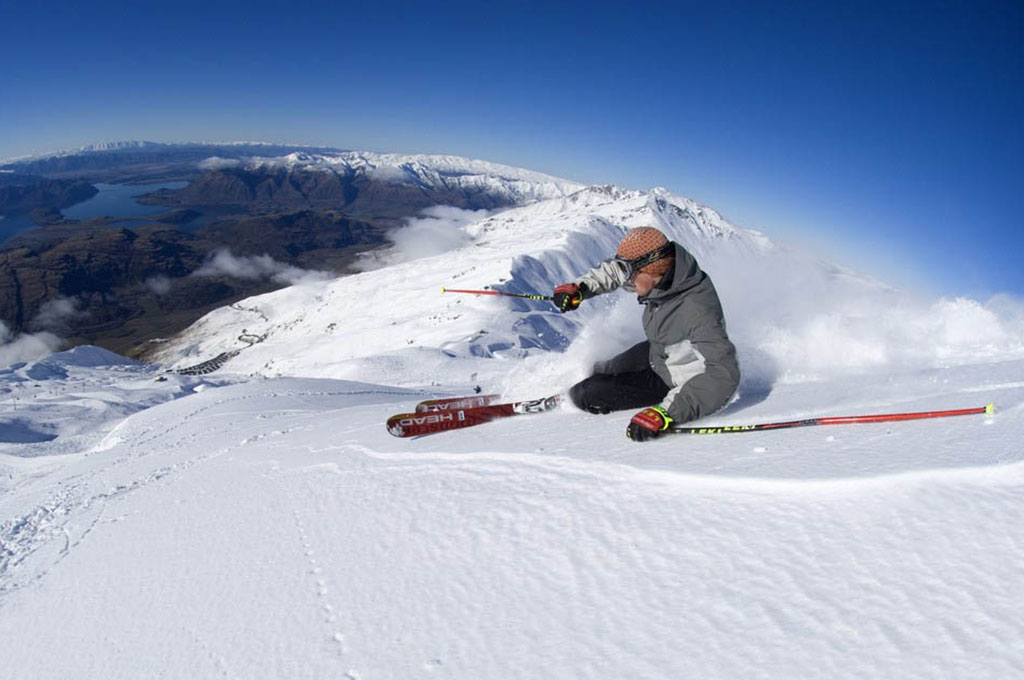 Skier coming down mountain in Wanaka, New Zealand